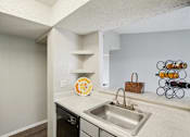 Thumbnail 54 of 63 - kitchen with stainless steel sink and black dishwasher at The Keller, San Antonio, TX  