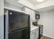 Thumbnail 53 of 63 -  kitchen with refrigerator, stove, oven and microwave at The Keller, San Antonio  