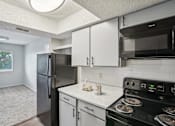 Thumbnail 52 of 63 - a kitchen with light colored cabinets and black appliances at The Keller, Texas  