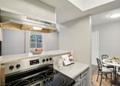 Thumbnail 7 of 63 - a kitchen with a stove and a table with chairs at The Keller, Texas  
