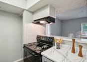 Thumbnail 40 of 63 - the kitchen of a 1 bedroom apartment home with a stove and oven and a window at The Keller, Texas  