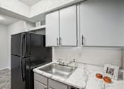 Thumbnail 39 of 63 - a kitchen with light color cabinets and a sink and a refrigerator at The Keller, San Antonio, TX  