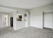 Thumbnail 51 of 63 - a living room with white walls and carpet at The Keller, San Antonio Texas  