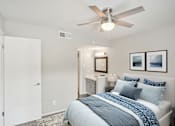 Thumbnail 11 of 63 - a bedroom with a bed and a ceiling fan at The Keller, San Antonio, TX  