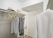 Thumbnail 15 of 63 - a closet with a white shirt and a hat hanging on a rack at The Keller, San Antonio Texas  