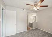 Thumbnail 45 of 63 - an bedroom with a ceiling fan and a bathroom at The Keller, Texas  