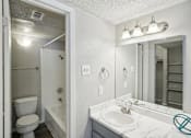 Thumbnail 46 of 63 - a bathroom with a sink and a mirror and a toilet at The Keller, San Antonio Texas  
