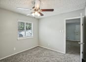 Thumbnail 43 of 63 - a bedroom with a ceiling fan and a window at The Keller, Texas, 78230