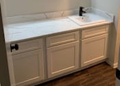 Thumbnail 15 of 15 - a renovated bathroom with a sink and a mirror at Peaks at Northwest Hills Apartments, Texas