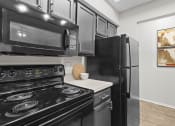 Thumbnail 45 of 55 - a kitchen with black appliances and black refrigerator