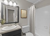 Thumbnail 40 of 55 - a bathroom with a shower and a sink and a toilet