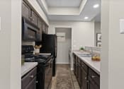 Thumbnail 52 of 55 - view of kitchen with black appliances and counter tops with sink and black refrigerator and stove