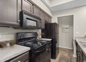 Thumbnail 46 of 55 - a kitchen with black appliances and black refrigerator