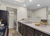Thumbnail 54 of 55 - the expansive kitchen with granite countertops and black appliances