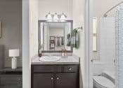 Thumbnail 53 of 55 - a bathroom with a sink and a mirror and a toilet