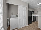 Thumbnail 25 of 32 - A laundry room with a washer and dryer in it.