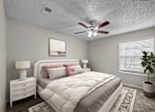 Thumbnail 29 of 32 - A bedroom with a bed, nightstand, and a ceiling fan.