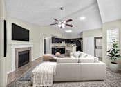 Thumbnail 16 of 32 - A living room with a fireplace and a couch.