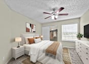 Thumbnail 21 of 32 - A bedroom with a bed, nightstand, and a ceiling fan.