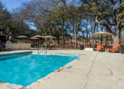 Thumbnail 14 of 60 - One of our Two Pools with an Outdoor Grilling Center at Maxwell Townhomes, San Antonio, TX