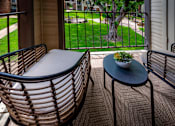 Thumbnail 10 of 10 - A table with a bowl of fruit on it sits on a patio.