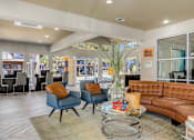 Thumbnail 3 of 28 - A living room with a brown couch and blue chairs.