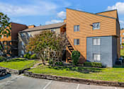 Thumbnail 15 of 28 - A modern building with a car parked in front.