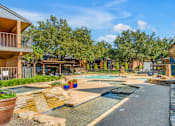 Thumbnail 5 of 28 - A residential area with a pool and a small waterfall.
