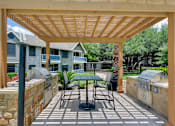Thumbnail 5 of 38 - a patio with a table and chairs under a pergola