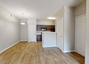 Thumbnail 31 of 42 - an empty living room and kitchen with wood flooring at Southgate Glen, Weatherford, TX