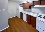 Thumbnail 42 of 54 - a kitchen with white appliances and brown cabinets at The Frederick, Texas
