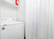 Thumbnail 14 of 34 - A white washing machine with a blue and white sticker on it.