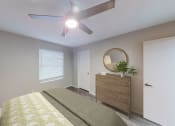 Thumbnail 41 of 54 - a bedroom with a ceiling fan and a dresser with a plant at The Frederick, Texas, 78240
