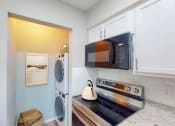 Thumbnail 36 of 54 - a laundry room with a washer and dryer at The Frederick, San Antonio, TX 78240