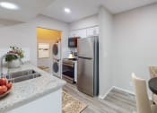 Thumbnail 32 of 54 - a kitchen and dining area in a 555 waverly unit at The Frederick, San Antonio