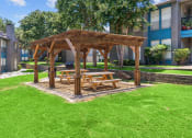 Thumbnail 19 of 58 - a wooden gazebo with a picnic table in the middle of a grassy area  at Vesper, Dallas, Texas