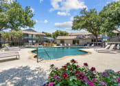 Thumbnail 1 of 58 - a pool with lounge chairs and trees in the background  at Vesper, Texas