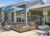 Thumbnail 15 of 58 - a patio with a blue awning in front of a gray house  at Vesper, Dallas, 75254