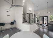 Thumbnail 11 of 58 - a living room with white walls and a staircase with black railings  at Vesper, Dallas