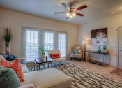 Thumbnail 3 of 18 - A living room with a couch, chair, and a rug.