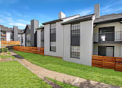 Thumbnail 12 of 27 - A row of modern houses with white walls and dark roofs.