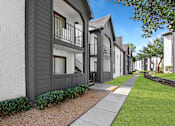 Thumbnail 14 of 27 - A row of modern townhouses with balconies and greenery.