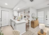 Thumbnail 6 of 47 - a kitchen and living room with white walls and a wooden floor  at Carmel at Deerfield, San Antonio, TX