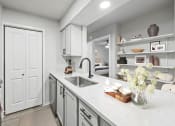 Thumbnail 5 of 47 - a kitchen with white cabinets and a white counter top  at Carmel at Deerfield, San Antonio