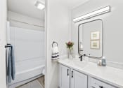Thumbnail 9 of 47 - a bathroom with a sink and a mirror  at Carmel at Deerfield, Texas