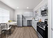 Thumbnail 3 of 79 - a kitchen with white cabinetry and stainless steel appliances  at Sunset Heights, San Antonio, TX, 78209