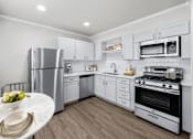 Thumbnail 4 of 79 - a kitchen with white cabinetry and stainless steel appliances  at Sunset Heights, San Antonio, Texas