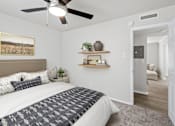 Thumbnail 13 of 79 - our apartments offer a bedroom with a king sized bed  at Sunset Heights, San Antonio, TX, 78209
