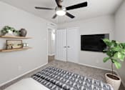Thumbnail 15 of 79 - a bedroom with a ceiling fan and a tv on the wall  at Sunset Heights, San Antonio, TX