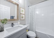 Thumbnail 11 of 79 - a bathroom with a white sink and toilet next to a white bathtub with a shower curtain  at Sunset Heights, Texas
